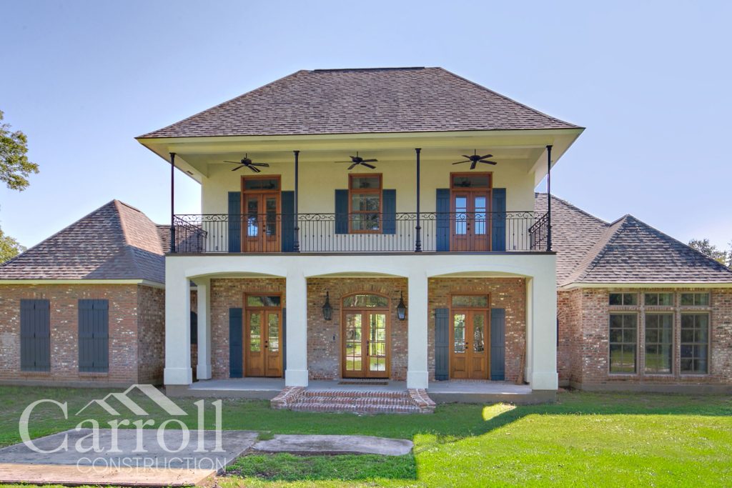 Front Elevation Custom home in Iberville by Carroll Construction for the Alvarez Family. French Country Style.