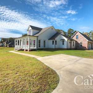 Customized Liberty Plan – Angled front view with brick garage and extended porch