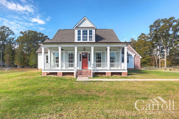 Acadian farmhouse front elevation with red door and prominent dormer