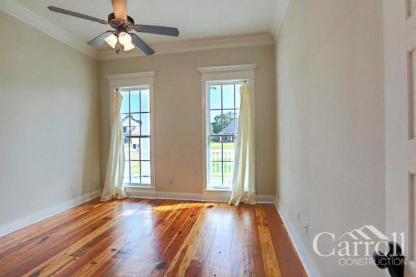 Kids bedroom at front corner of home with heart pine wood flooring