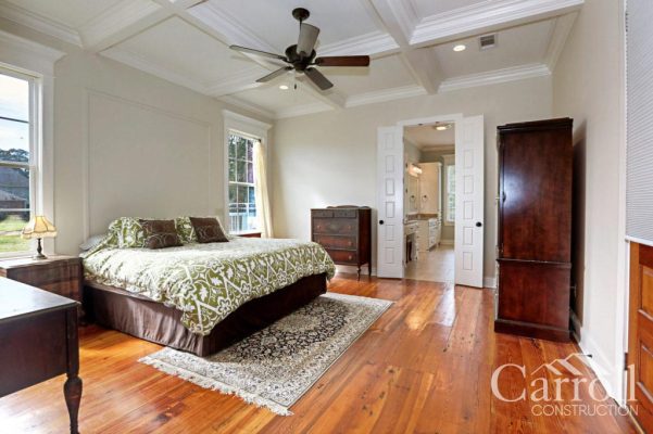 Master bedroom with coffered ceiling and heart pine wood flooring