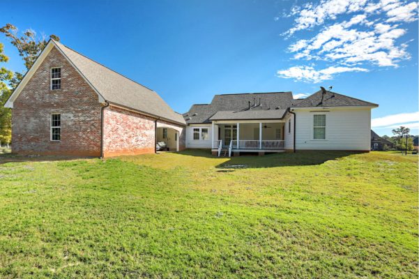 Backyard view facing rear porch and California-style carport