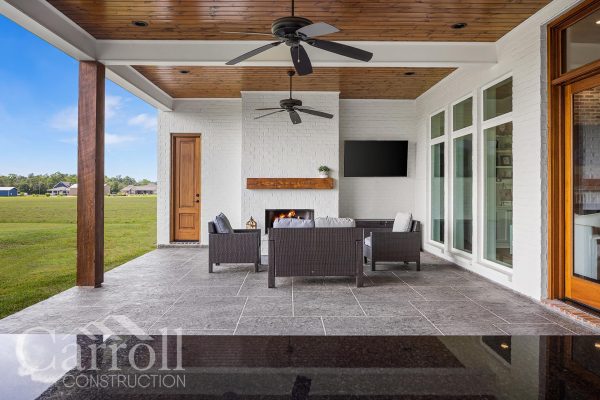 Stained wood back porch with painted brick fireplace and slate-style acrylic overlay – Necker Family