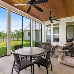 Dittmar Home – Liberty plan, 2,574 SF – porch with stained wood v-groove ceiling and multiple windows